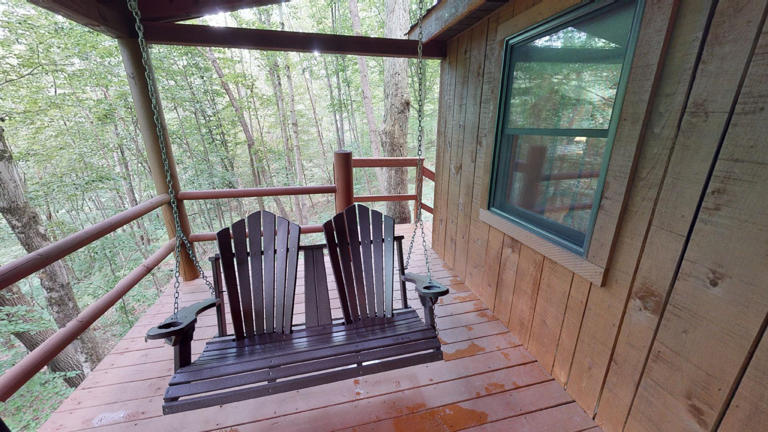 hocking hills cabins nestled away swing on deck